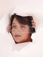 Woman peeking though paper hole