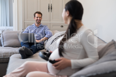 Couple interacting with each other in living room