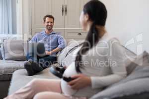 Couple interacting with each other in living room