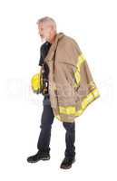 A firefighter standing in profile
