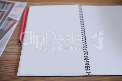 Blank notepad and pencil on wooden table