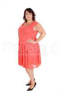 A plus size woman standing in a dress