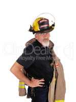 A firefighter standing with his helmet on