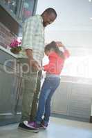 Father and daughter dancing together in kitchen