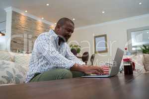 Man using laptop in living room