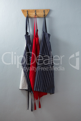 Various aprons hanging on hook