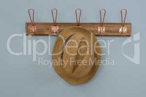 Straw hat hanging on hook