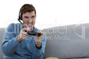 Man playing video game against white background