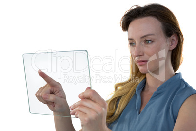 Female executive using glass digital tablet