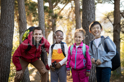 Portrait of kids and teacher standing in park