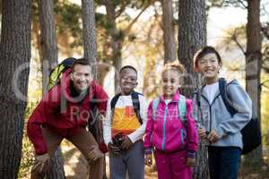 Portrait of kids and teacher standing in park