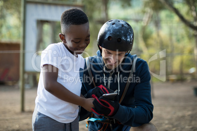 Instructor and kid using mobile phone