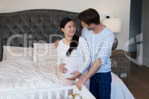 Couple feeling the presence of baby in her stomach