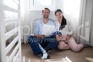 Portrait of happy couple sitting with document