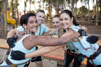 Portrait of fit friends forming huddle