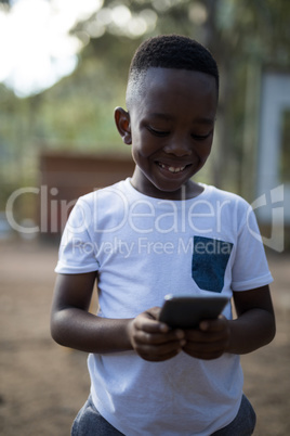 Close-up of cute boy using mobile phone