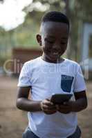 Close-up of cute boy using mobile phone