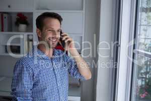 Happy man talking on mobile phone
