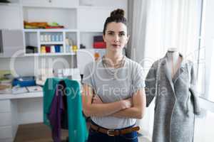 Fashion designer standing with arms crossed
