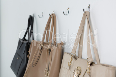 Various handbags hanging on hook