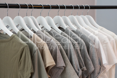 Various t-shirts hanging on cloth hanger
