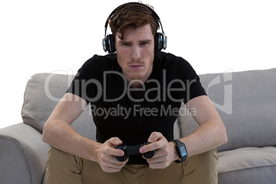 Man playing video game against white background