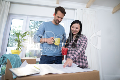 Couple looking at the blueprint of their new home