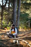 Boy studying in forest