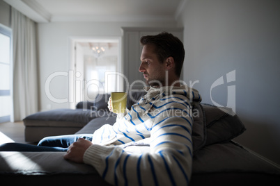 Man having coffee in the living room