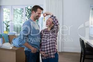 Pregnant couple holding key of their new house