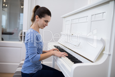 Beautiful woman playing piano