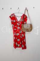 Red dress and bag hanging on hook