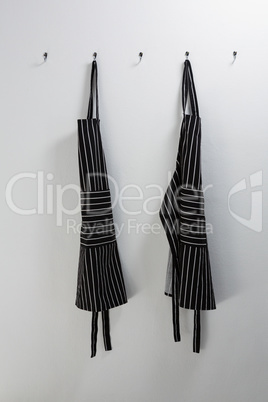 Aprons hanging on hook