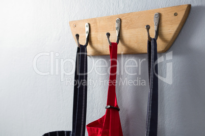 Various aprons hanging on hook