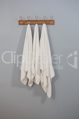 White towels hanging on hook