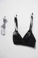 Lingerie and bow tie hanging on hook