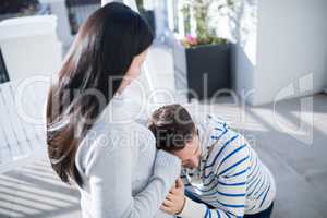 Ma listening the belly of his wife in balcony