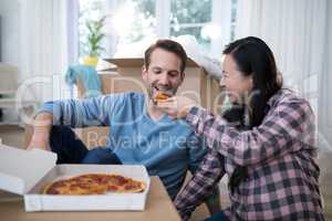 Couple having pizza at their new home
