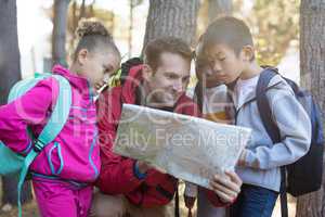 Teacher and kids reading map