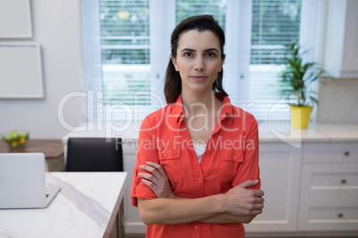 Confident woman standing with arms crossed