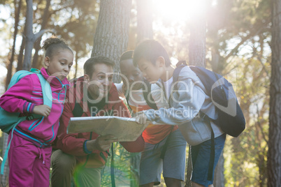 Teacher and kids reading map