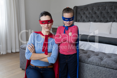 Portrait of Mother and daughter pretending to be superhero