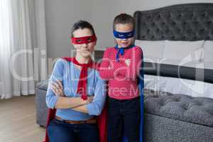 Portrait of Mother and daughter pretending to be superhero