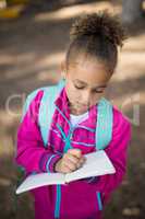 Close-up of girl writing in book