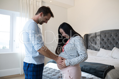 Man touching pregnant woman stomach