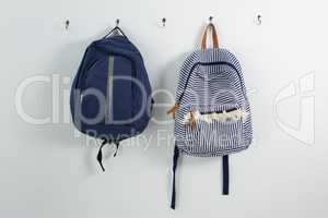 Schoolbags hanging on hook