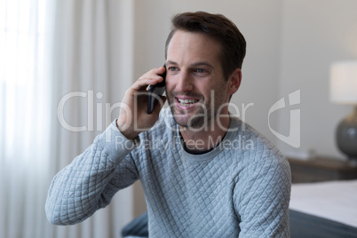 Happy man talking on mobile phone