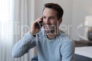 Happy man talking on mobile phone