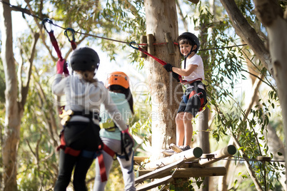 Determined kids crossing zip line