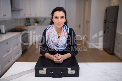 Portrait of confident woman standing at table